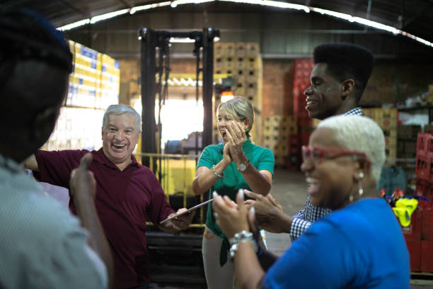 istock Happy employees celebrating together at warehouse 1184931449
