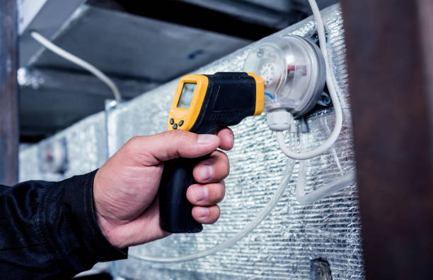istock Technician use infrared thermal imaging camera to check temperature at fuse-box 1184931561