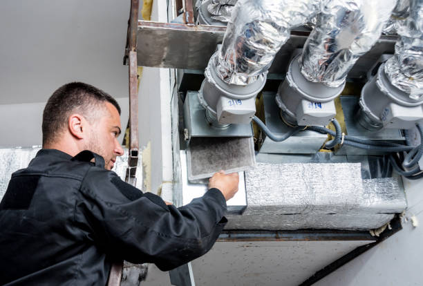 istock Ventilation cleaning. Specialist at work. Repair ventilation system (HVAC) 1184933352