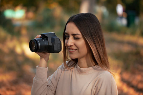 istock young woman with a camera 1184935082