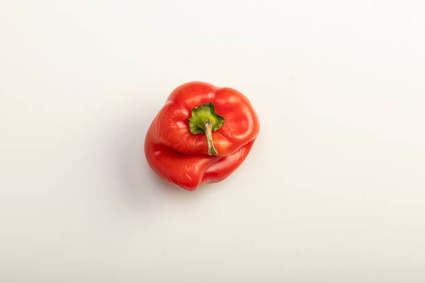istock Ugly red bell pepper on white backgroun 1184935186