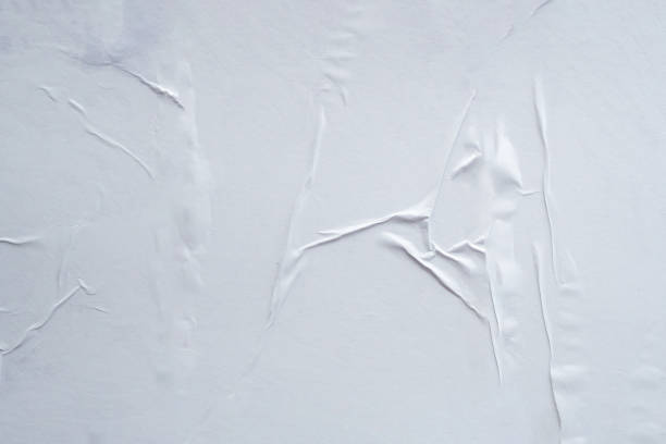 istock Blank white crumpled and creased paper poster texture background 1184935342