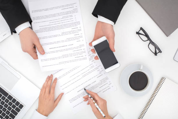 istock Two business people at office top view 1184935357