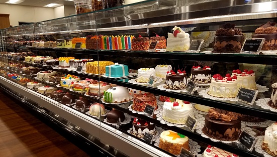 Colorful rows of decorated cakes of all kinds and ready for purchase.  Not exactly low calorie items, but fun food, entertaining ideas.
