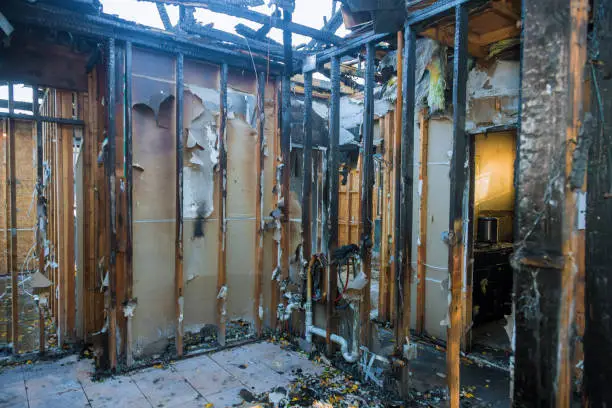 Photo of Burnt wooden walls house with charred roof burnt