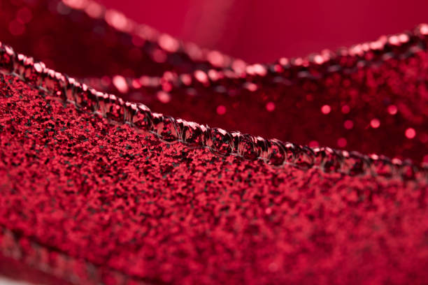 istock Macro abstract image texture of sparkling red glitter ribbon with bokeh 1184942559