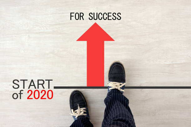 istock Man standing on starting line of 2020 1184943446