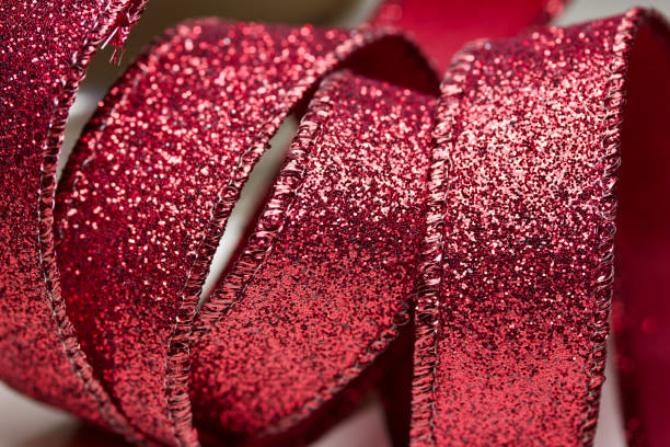 istock Macro abstract image texture of sparkling red glitter ribbon with bokeh 1184943586