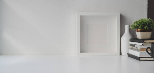 istock Minimal office room with copy space and decorations on white wooden table 1184955988
