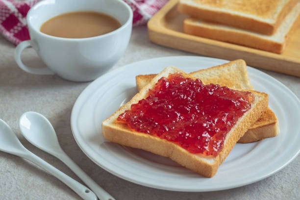 istock Toast bread with strawberry jam on plate and coffee cup 1184960336