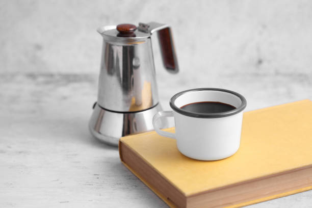 istock Coffee in cup and books on rustic table with a blank space for a text, Espresso in cup on white background 1184963755