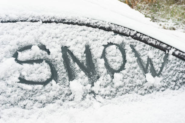 istock Snow-covered car windshield. parked car covered with snow during snowing in winter time. 1184967214