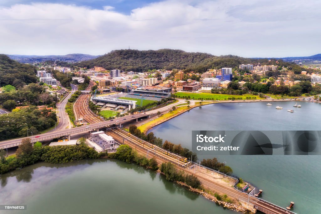 D Gosford Town Trains Sky Central coast town Gosford at intersection of Central coast highway and railway between hill ranges on shores of Brisbane water bay - aerial view over town centre. Gosford Stock Photo