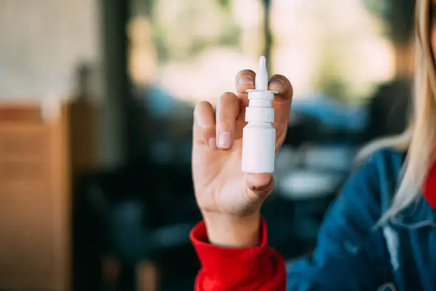 Young Woman Holding Nasal Spray