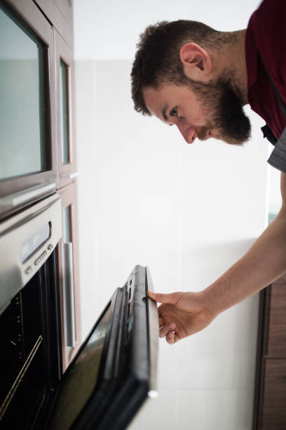 istock Man open an electric oven 1184974983