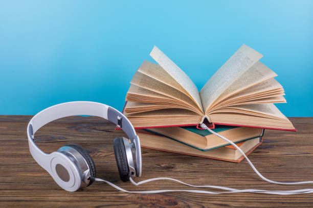 istock Headphones plugged into an open book. 1184979954