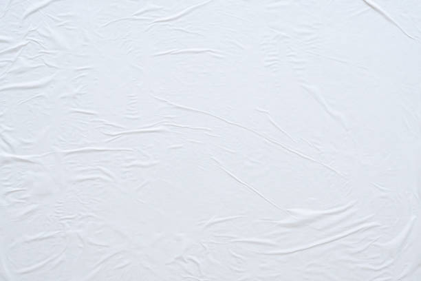 istock Blank white crumpled and creased paper poster texture background 1184990536