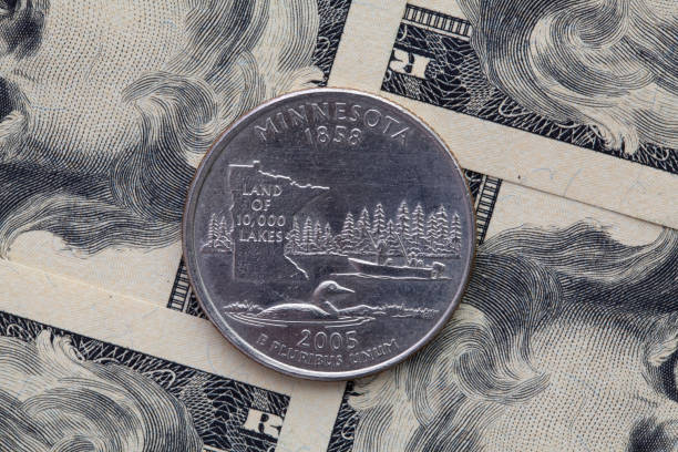A quarter of Minnesota on US dollar bills. Symmetric composition of US dollar bills and a quarter of Minnesota.
