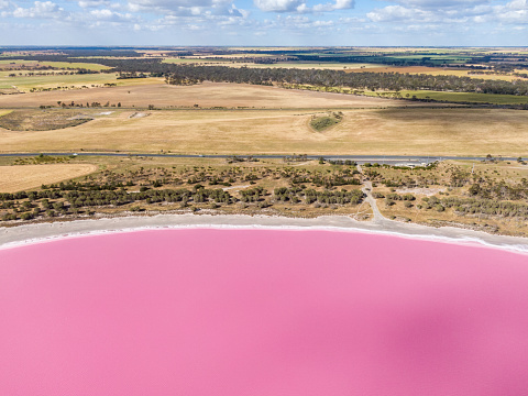 Aerial high angle drone view of Loch Iel, also called Pink Lake, near the village of Dimboola in Victoria, Australia. The pink color results from red pigment secreted by microalgae in summer.