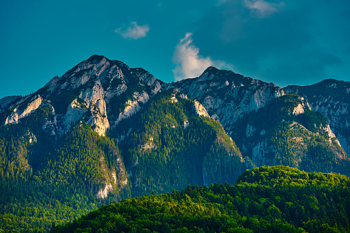 Vibrant colors of mountains in Romania, cloudscape and forest