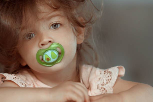 Sweet baby girl making a face inside the house