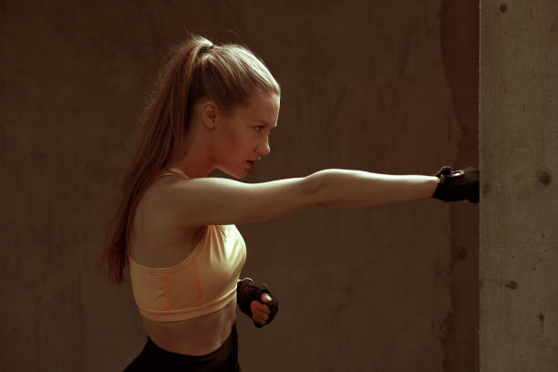 istock Determined girl punching the wall 1184997688