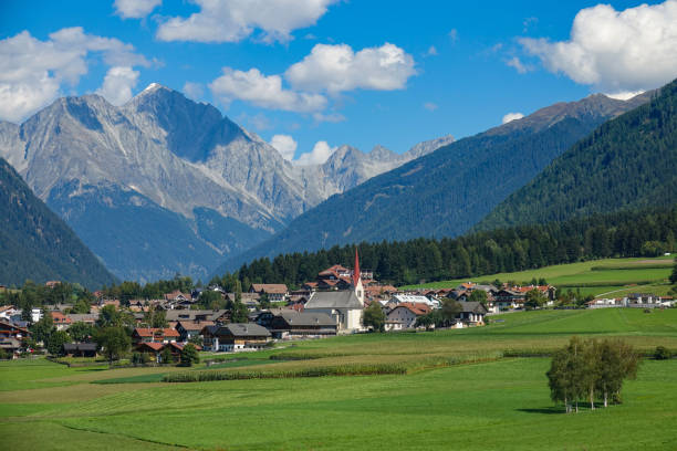istock AERIAL: Flying over the empty meadows and towards an idyllic village in Austria. 1185002074