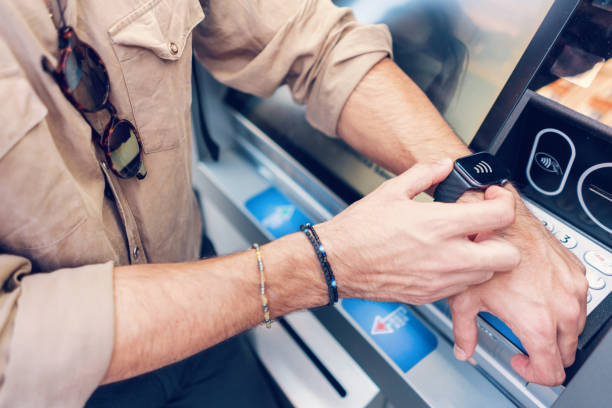 istock Man making transactions at the ATM with his smart watch 1185002233