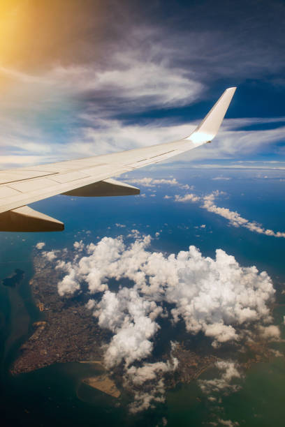 istock Wing of airplane in cloudy sky 1185003456