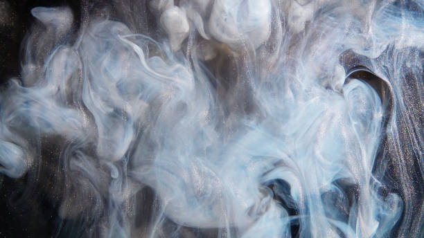 istock Abstract bronze paint mixed with different multi-colored paints in water in slow motion. Inky cloud swirling flowing underwater. Abstract smoke explosion 1185003477