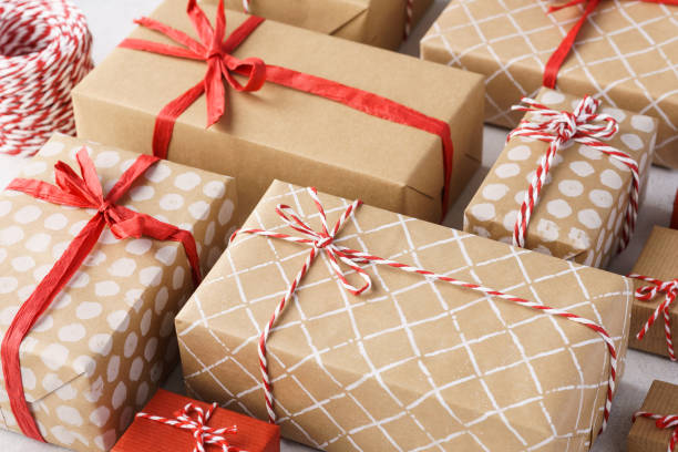 istock Paper wrapped gift boxes decorated with red ribbon and twine. 1185004548