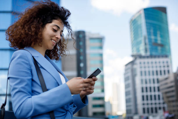 istock Young businesswoman using mobile phone outdoor 1185007040