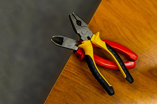 tool home master. Pliers rubber handles on a wooden lathe two pairs