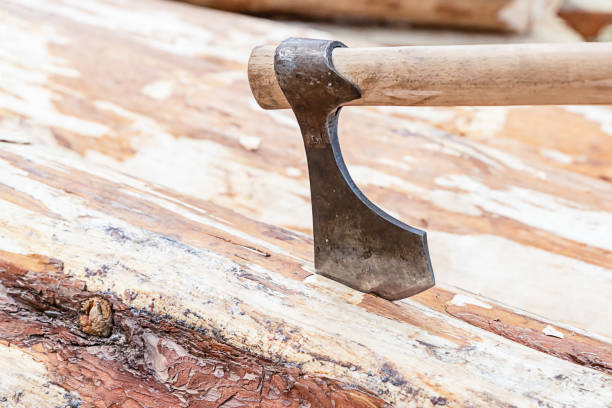 istock closeup ax old stuck in wood work tool construction background 1185008298