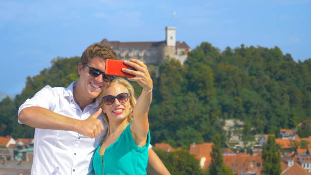 istock CLOSE UP: Smiling man gives the thumbs up while taking selfies with girlfriend. 1185008505