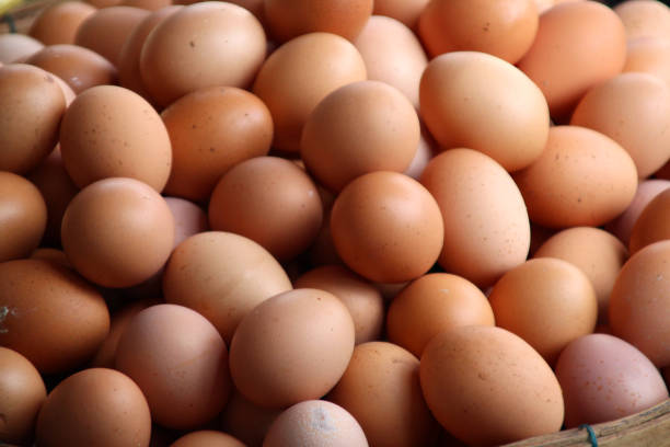 istock Brown fresh chicken eggs in a basket in a market 1185013539