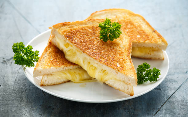 istock Grilled Cheese cheddar Sandwich on white plate 1185013564