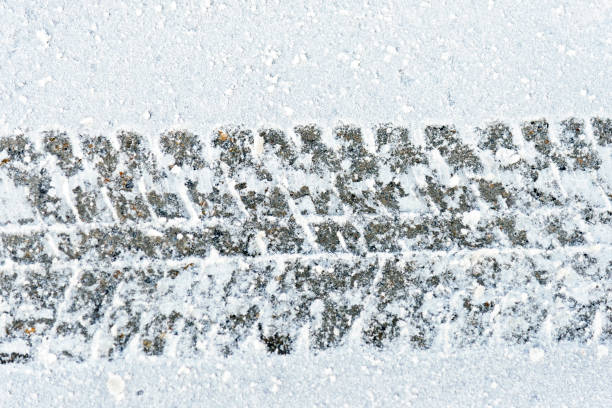 istock Tire tracks on the snowy ground under blizzard. 1185013738