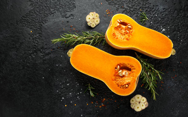 istock Fresh Butternut squash with rosemary, garlic, chilli flake and salt on black rustic background 1185013820