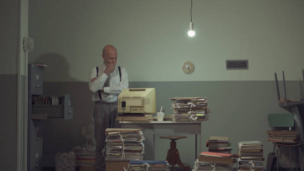 istock Businessman searching for files in a messy office 1185015923