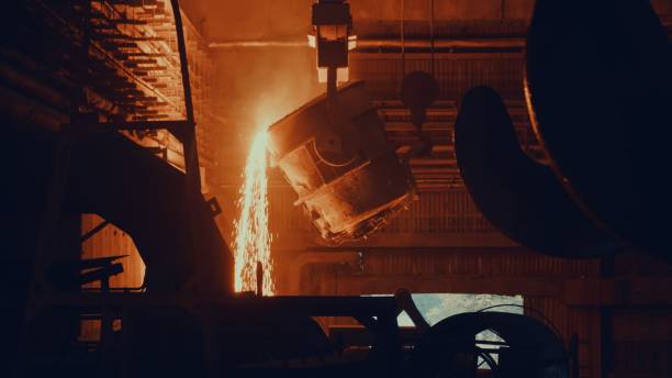 Steel mill factory - molten metal in vat stock photo