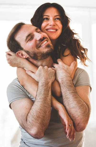 istock Happy woman hugging her husband 1185016127