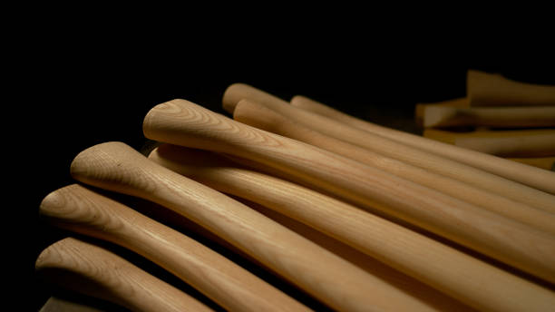 istock CLOSE UP: Smooth long wooden tool handles rest on the craftsman's work desk. 1185016182
