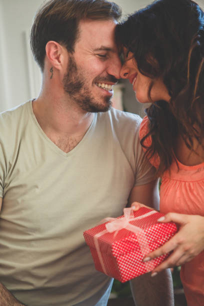 istock Happy woman receiving a gift from her husband 1185017978