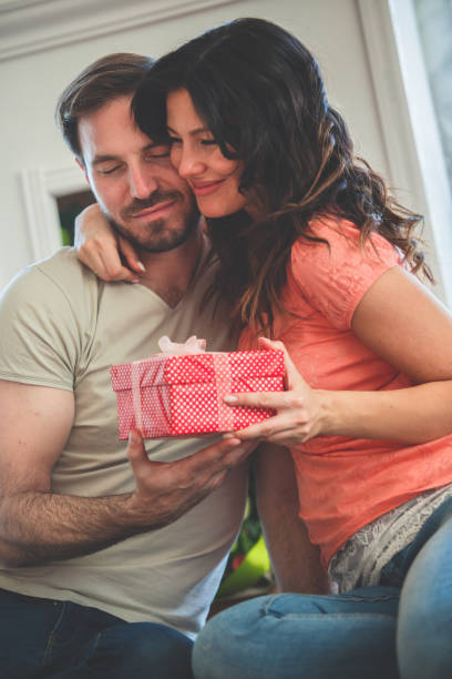 istock Couple exchanging gifts at home 1185017983