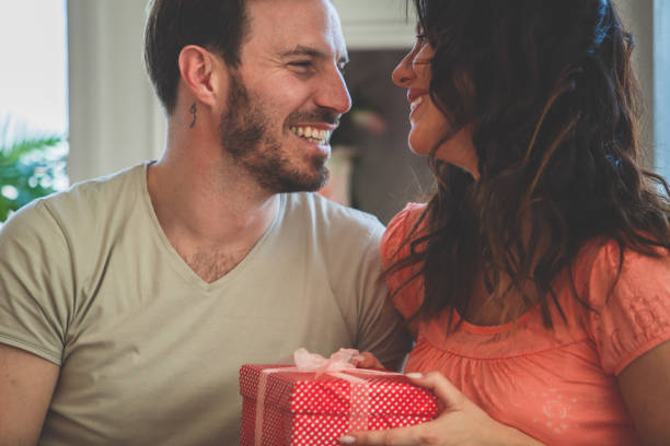 istock Woman receiving a gift from her husband 1185017984