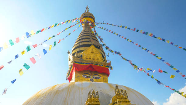 istock LENS FLARE: Colorful prayer flags flutter in the wind blowing over Monkey Temple 1185018407