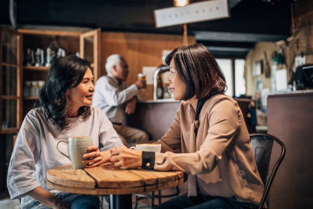 istock Friends drinking coffee in cafe 1185019050