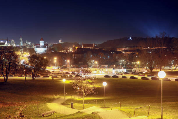 Vilnius city illuminated at night with Gediminas tower, three crosses and Church of the Holy Mother of God from bastion hill