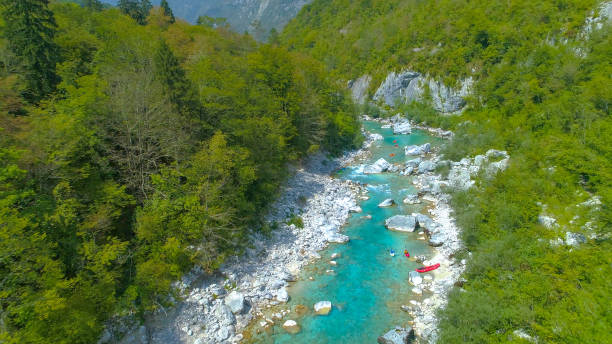istock DRONE: Active tourists kayaking and rafting on glassy Soca river in the summer. 1185021635